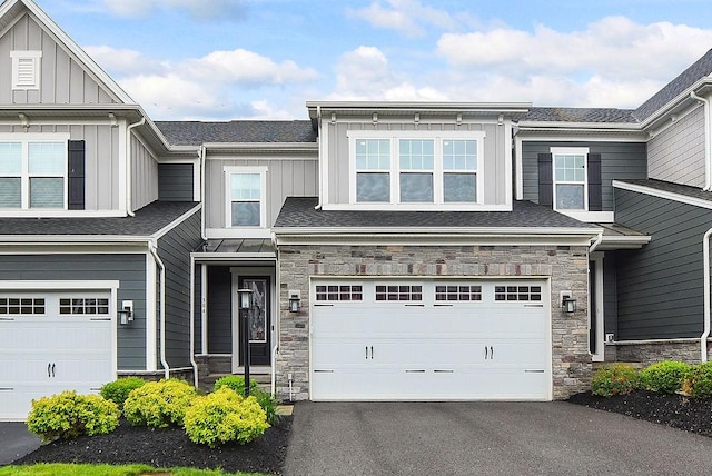 304 Spruce Ln, North Strabane, PA 15317 - view of front facade featuring stone siding, board and batten siding, an attached garage, and driveway