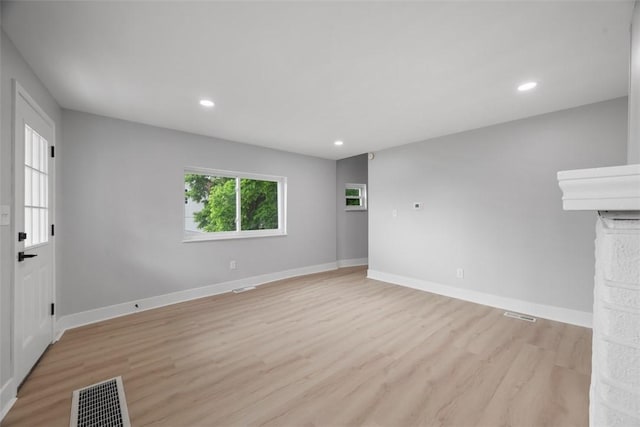 5437 Rosetta St, Garfield, PA 15206 - unfurnished living room featuring light wood-style flooring, baseboards, and recessed lighting