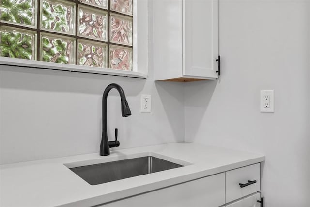 5437 Rosetta St, Garfield, PA 15206 - detailed view of a sink, white cabinets, and light countertops