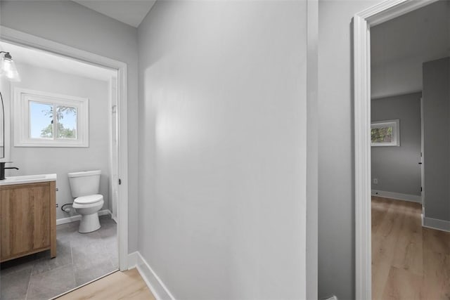 5437 Rosetta St, Garfield, PA 15206 - bathroom featuring toilet, vanity, wood finished floors, and baseboards