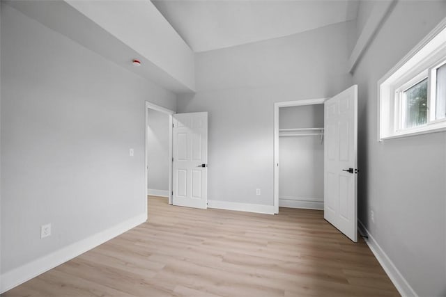 5437 Rosetta St, Garfield, PA 15206 - unfurnished bedroom with light wood-style floors, baseboards, a closet, and high vaulted ceiling