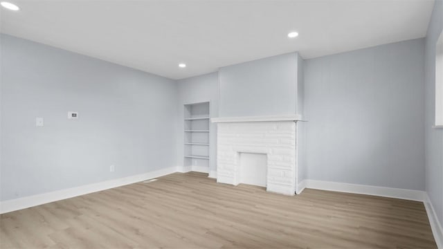 5437 Rosetta St, Garfield, PA 15206 - unfurnished living room featuring wood finished floors, recessed lighting, and built in features