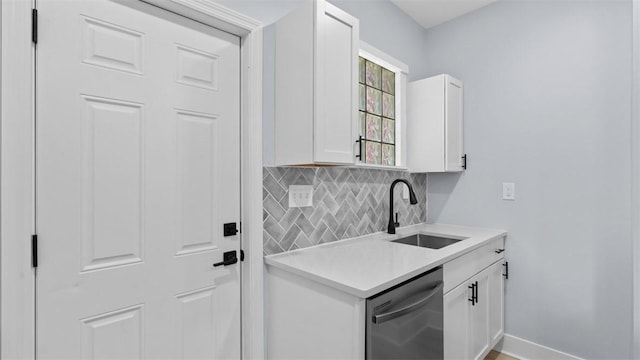 5437 Rosetta St, Garfield, PA 15206 - kitchen with stainless steel dishwasher, backsplash, light countertops, and white cabinets