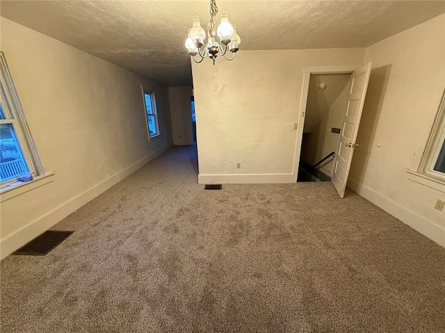 2828 Oak St, Bethel Park, PA 15102 - carpeted spare room featuring a textured ceiling, a chandelier, and baseboards