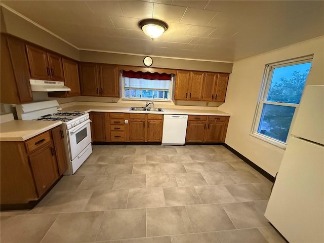 2828 Oak St, Bethel Park, PA 15102 - kitchen featuring white appliances, a sink, under cabinet range hood, brown cabinetry, and light countertops