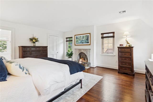 254 Orchard Dr, Mt Lebanon, PA 15228 - bedroom with multiple windows, dark wood finished floors, a lit fireplace, and baseboards