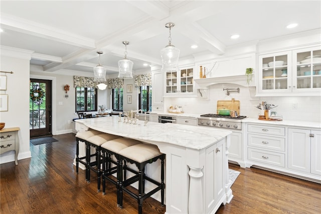 254 Orchard Dr, Mt Lebanon, PA 15228 - kitchen with stainless steel gas stovetop, white cabinetry, decorative backsplash, a kitchen island, and dark wood-type flooring