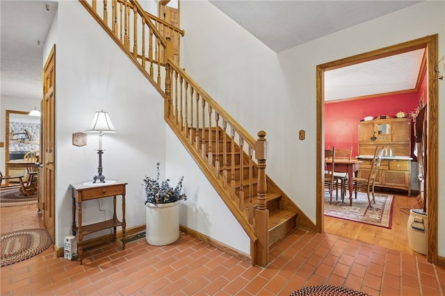 150 Greenfield Rd, Neshannock Twp, PA 16105 - stairs featuring baseboards, brick patterned floors, and a textured ceiling