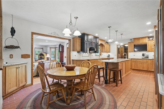 150 Greenfield Rd, Neshannock Twp, PA 16105 - dining area with brick floors, a textured ceiling, a chandelier, and recessed lighting