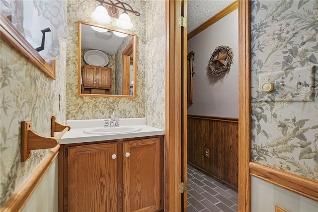 150 Greenfield Rd, Neshannock Twp, PA 16105 - bathroom with wallpapered walls, brick patterned floors, vanity, wainscoting, and crown molding