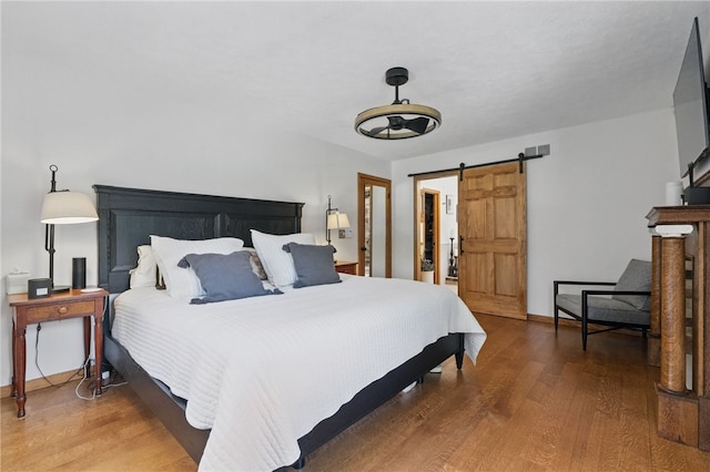 150 Greenfield Rd, Neshannock Twp, PA 16105 - bedroom with wood finished floors, a barn door, and baseboards
