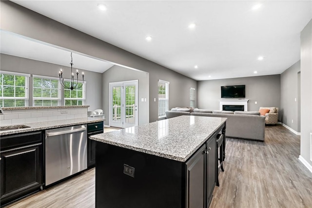 3017 Pelican Dr, Middlesex Twp, PA 16059 - kitchen featuring stainless steel dishwasher, dark cabinetry, light wood-type flooring, a center island, and recessed lighting