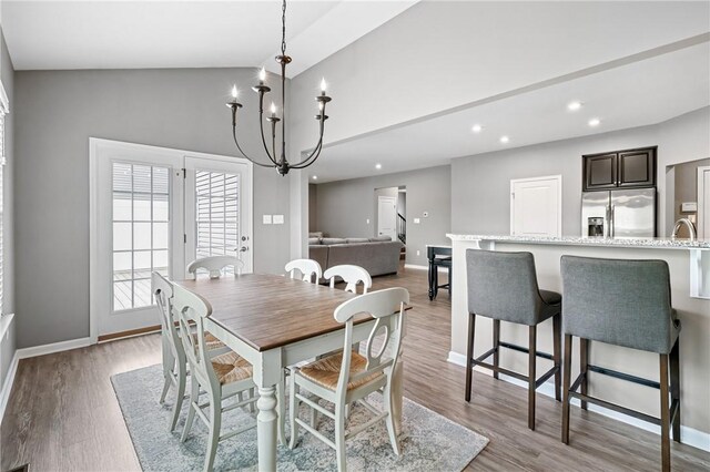 3017 Pelican Dr, Middlesex Twp, PA 16059 - dining room with baseboards, light wood-type flooring, recessed lighting, high vaulted ceiling, and a chandelier