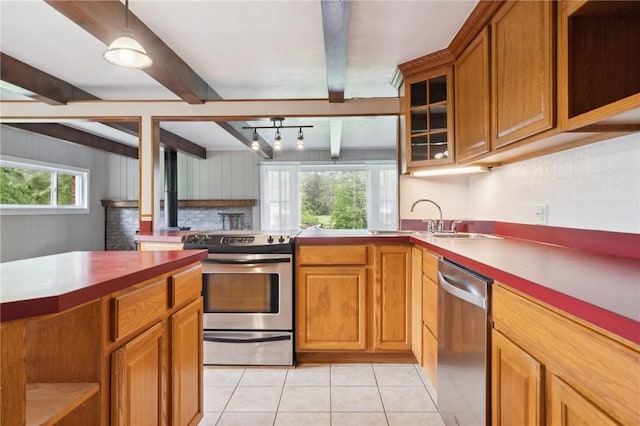 506 E End Road Ext, Bullskin Twp, PA 15425 - kitchen with stainless steel appliances, a sink, beam ceiling, brown cabinetry, and light tile patterned flooring