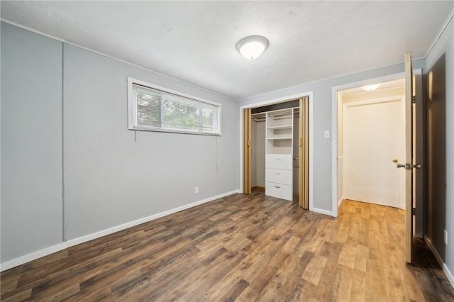 506 E End Road Ext, Bullskin Twp, PA 15425 - unfurnished bedroom with wood finished floors, crown molding, a closet, and baseboards