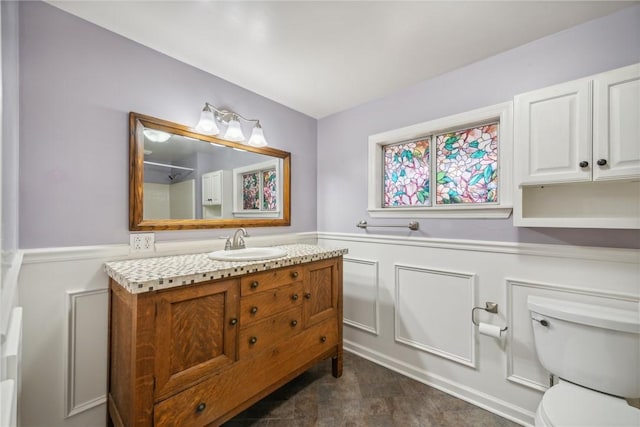 506 E End Road Ext, Bullskin Twp, PA 15425 - bathroom featuring a wainscoted wall, vanity, toilet, and a decorative wall