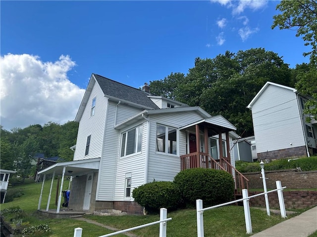 319 Wahl Ave, Evans City Boro, PA 16033 - view of front of home with a front yard, a chimney, and a shingled roof