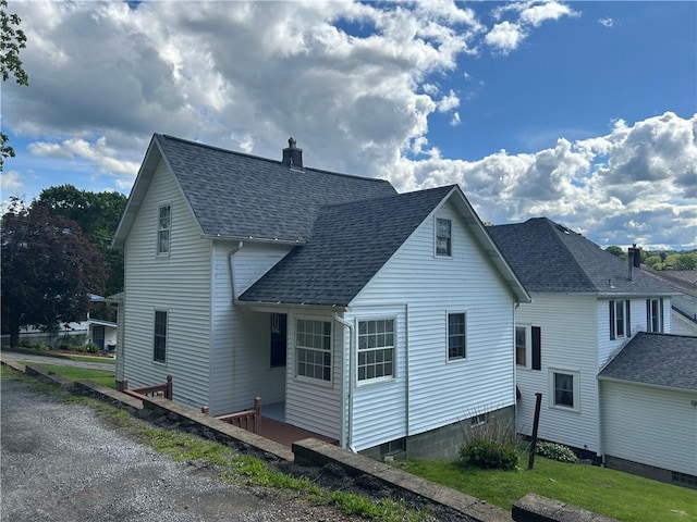 319 Wahl Ave, Evans City Boro, PA 16033 - view of side of home featuring a shingled roof and a chimney