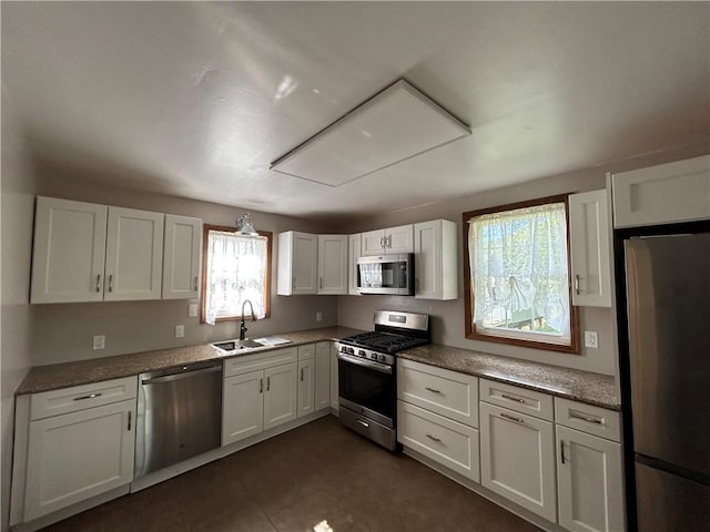 319 Wahl Ave, Evans City Boro, PA 16033 - kitchen featuring appliances with stainless steel finishes, a sink, plenty of natural light, and white cabinets