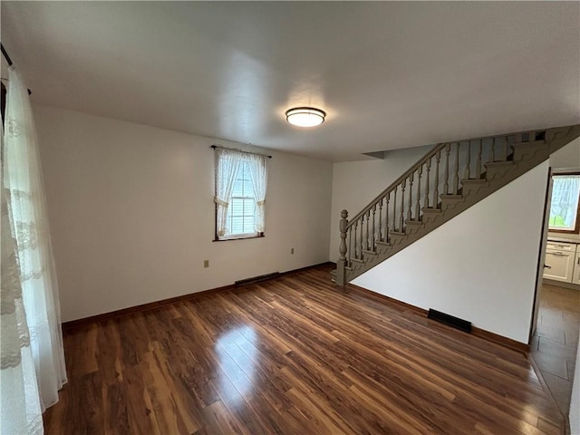 319 Wahl Ave, Evans City Boro, PA 16033 - spare room with stairs, dark wood-style floors, and baseboards