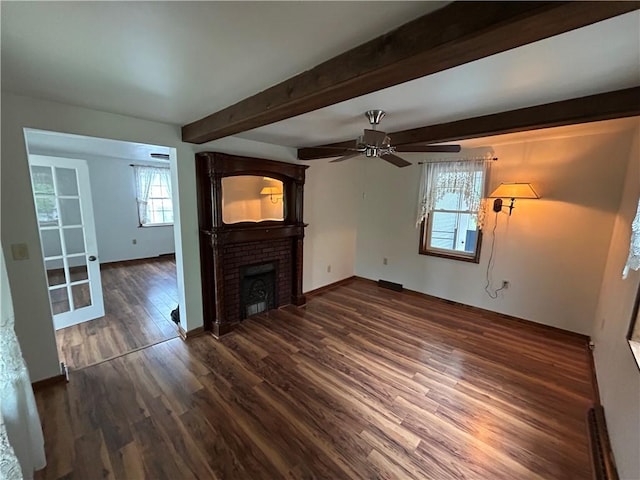 319 Wahl Ave, Evans City Boro, PA 16033 - unfurnished living room with dark wood-type flooring, a ceiling fan, beam ceiling, a brick fireplace, and baseboards