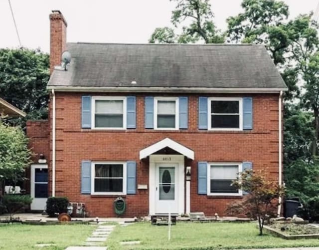 6611 Church Ave, Ben Avon, PA 15202 - view of front facade with a chimney, brick siding, a front lawn, and a shingled roof