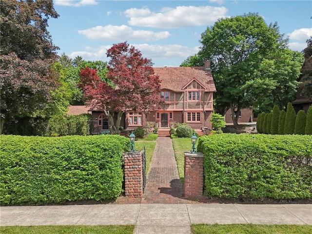 421 E Moody Ave, New Castle/2Nd, PA 16105 - tudor home featuring a chimney and brick siding