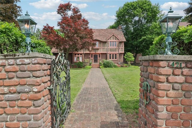 421 E Moody Ave, New Castle/2Nd, PA 16105 - english style home with a front yard, a gate, and brick siding