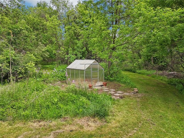 421 E Moody Ave, New Castle/2Nd, PA 16105 - view of grassy yard with a greenhouse, an outbuilding, and a forest view