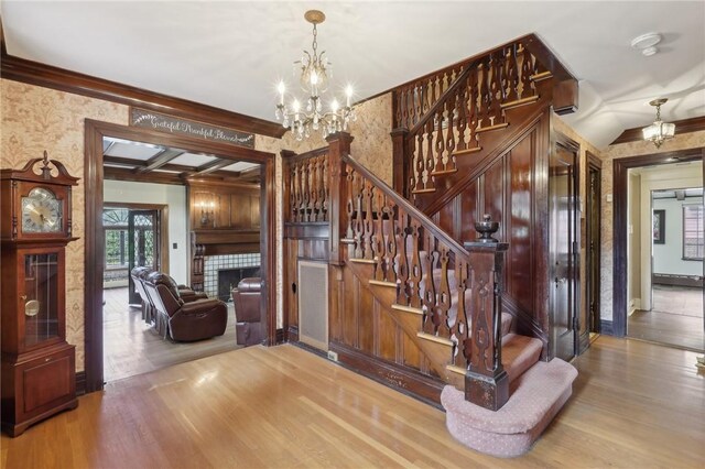 421 E Moody Ave, New Castle/2Nd, PA 16105 - stairway with a chandelier, wood finished floors, a fireplace, and crown molding