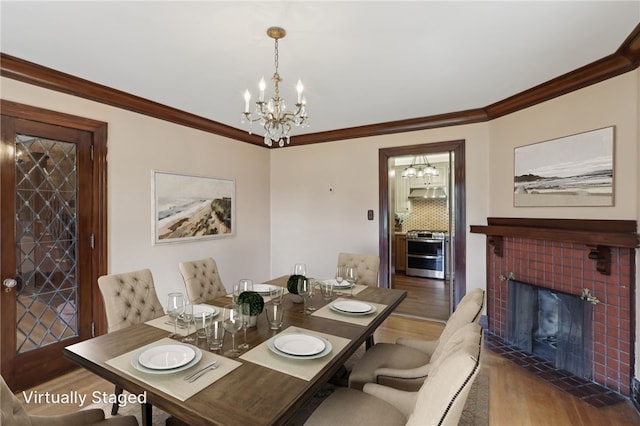421 E Moody Ave, New Castle/2Nd, PA 16105 - dining space featuring a chandelier, wood finished floors, ornamental molding, and a tile fireplace