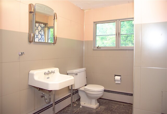 421 E Moody Ave, New Castle/2Nd, PA 16105 - bathroom with baseboard heating, tile walls, toilet, and a sink