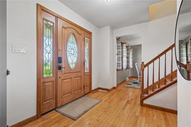 3405 Grandview Rd, Perry Twp Law, PA 16117 - foyer entrance featuring baseboards, hardwood / wood-style flooring, stairs, and a textured ceiling