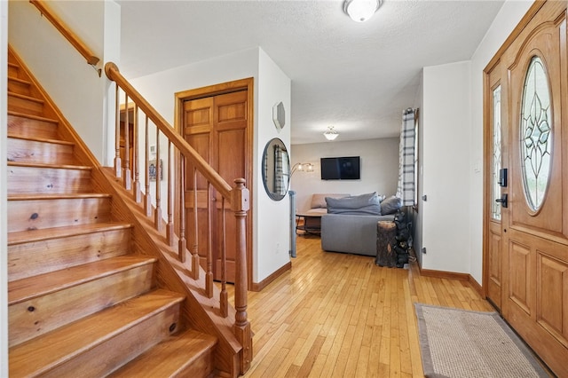 3405 Grandview Rd, Perry Twp Law, PA 16117 - entryway featuring baseboards, light wood-type flooring, stairs, and a textured ceiling