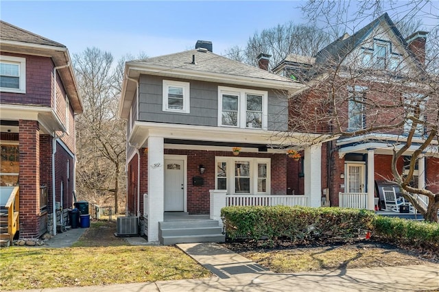 507 Greendale Ave, Edgewood, PA 15218 - traditional style home featuring covered porch, a chimney, brick siding, and cooling unit