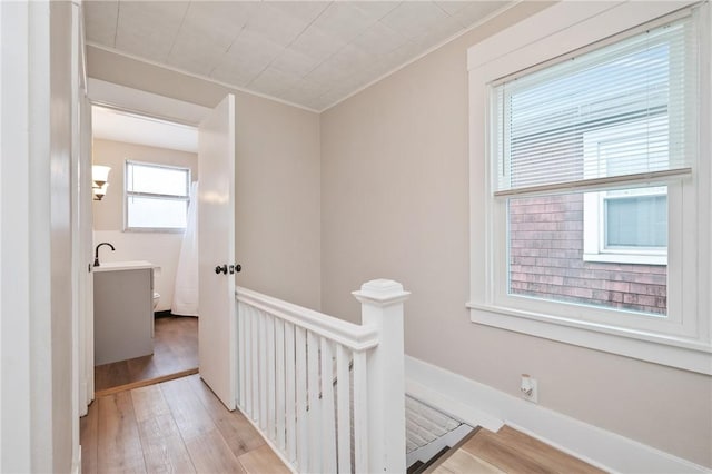507 Greendale Ave, Edgewood, PA 15218 - corridor with light wood-type flooring, an upstairs landing, crown molding, and a sink