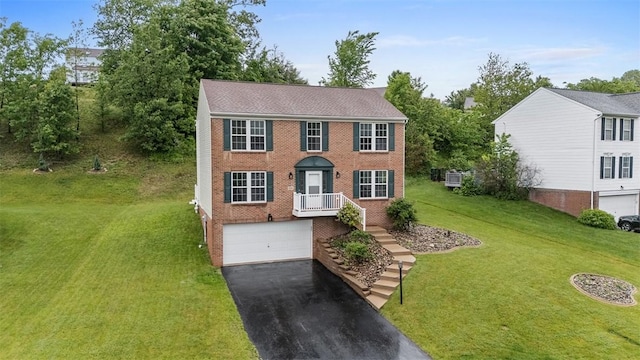 153 Birchwood Way, Irwin, PA 15642 - colonial home featuring brick siding, driveway, a garage, and a front lawn