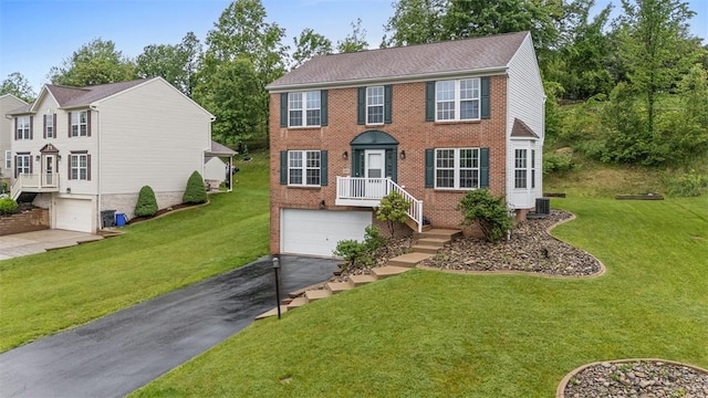 153 Birchwood Way, Irwin, PA 15642 - colonial inspired home with an attached garage, asphalt driveway, brick siding, and a front lawn