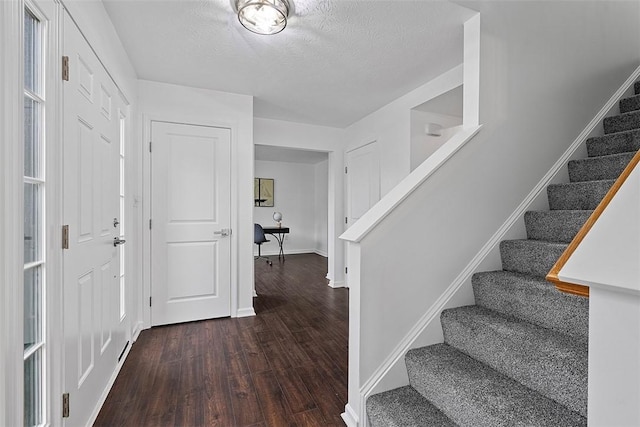 153 Birchwood Way, Irwin, PA 15642 - entrance foyer with dark wood-style flooring, stairway, baseboards, and a textured ceiling