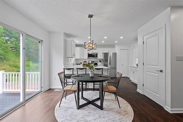 153 Birchwood Way, Irwin, PA 15642 - dining space with dark wood-style flooring, a chandelier, baseboards, recessed lighting, and a textured ceiling