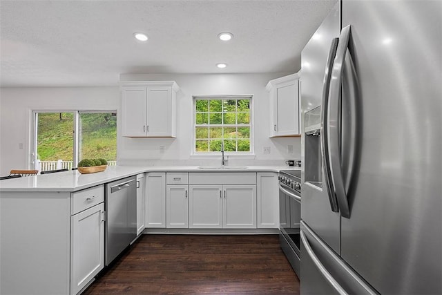153 Birchwood Way, Irwin, PA 15642 - kitchen featuring stainless steel appliances, a sink, a peninsula, white cabinetry, and recessed lighting