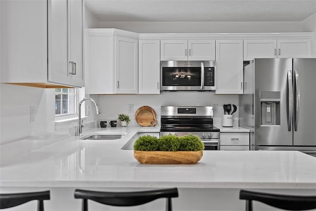 153 Birchwood Way, Irwin, PA 15642 - kitchen with appliances with stainless steel finishes, a sink, light countertops, and white cabinetry