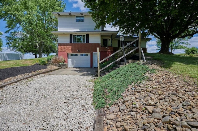 125 Srader Grove Rd, South Buffalo Twp, PA 16229 - view of front of property with driveway, brick siding, a garage, and stairway