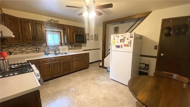 1303 Forest Ave, New Kensington, PA 15068 - kitchen featuring freestanding refrigerator, a sink, light countertops, and decorative backsplash