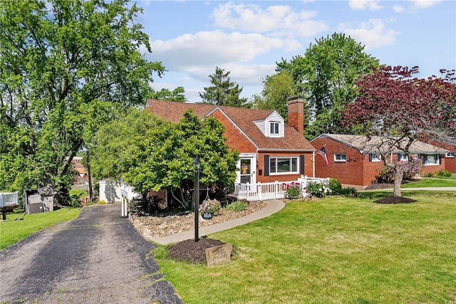 5101 Azalea Dr, Whitehall, PA 15236 - view of front of house featuring brick siding, a chimney, and a front lawn