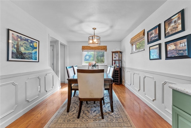5101 Azalea Dr, Whitehall, PA 15236 - dining room featuring light wood-style flooring, a wainscoted wall, and a decorative wall
