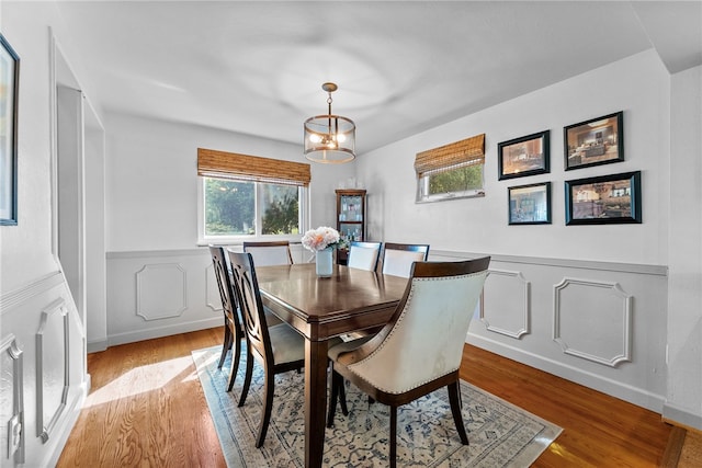 5101 Azalea Dr, Whitehall, PA 15236 - dining area featuring wood finished floors, a wainscoted wall, a decorative wall, and a chandelier