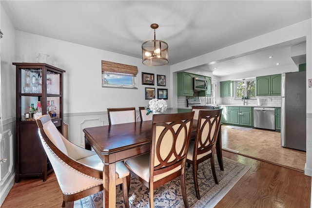 5101 Azalea Dr, Whitehall, PA 15236 - dining area with light wood-style flooring, plenty of natural light, and wainscoting
