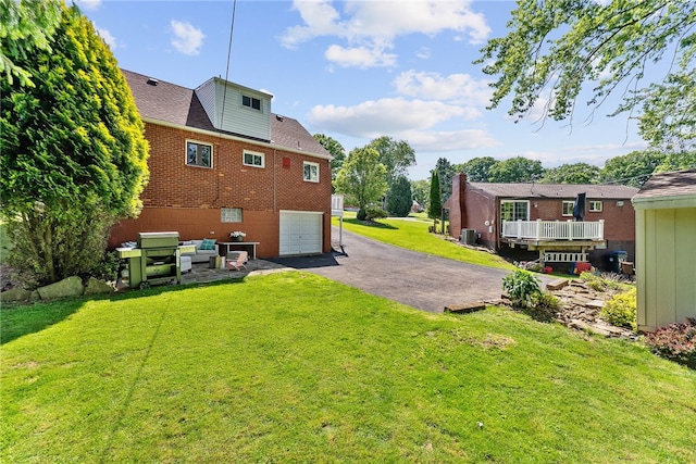 5101 Azalea Dr, Whitehall, PA 15236 - view of green lawn with driveway, a garage, and central AC unit