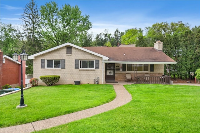 549 Dunn Dr, Whitehall, PA 15227 - view of front of house with brick siding, a front lawn, a chimney, and a patio area